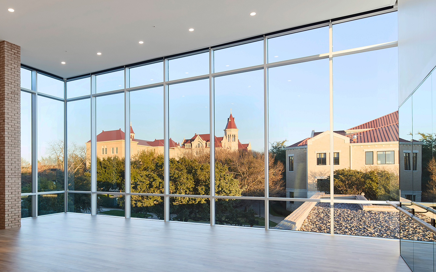 Multi-purpose space of Recreation and Athletic Center by Specht Novak Architects, showcasing the windows creating brightness in the space and connecting the user to the campus beyond. Shot by Andrea Calo.