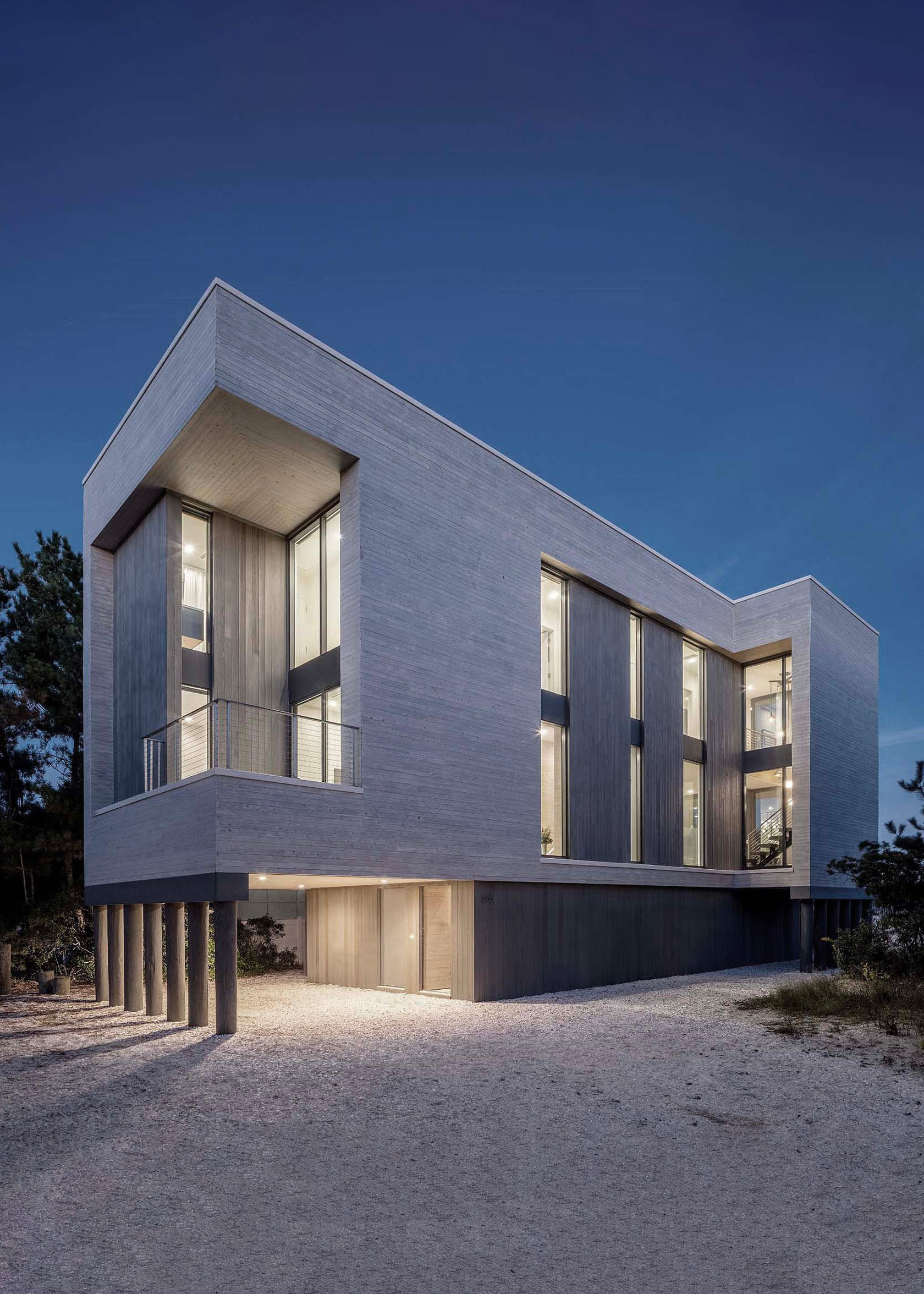 Exterior photo of the Beach Haven Residence by Specht Novak Architects. Shot by Taggart Sorenson featuring the facade of the home and sculptural lighting that highlight the structure in relation to its context.