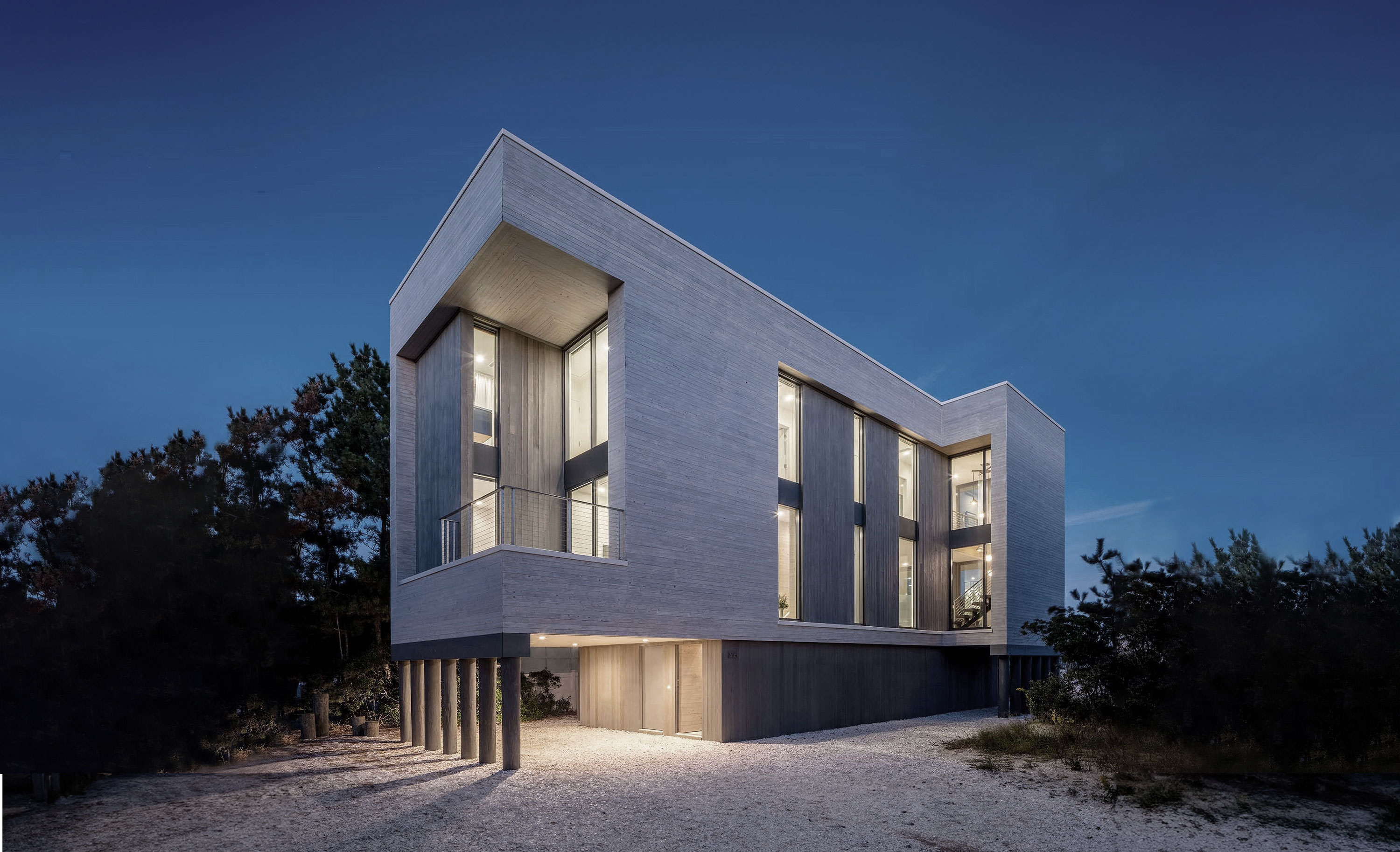 Exterior photo of the Beach Haven Residence by Specht Novak Architects. Shot by Taggart Sorenson featuring the angular facade of the home in relation to its beach surroundings.