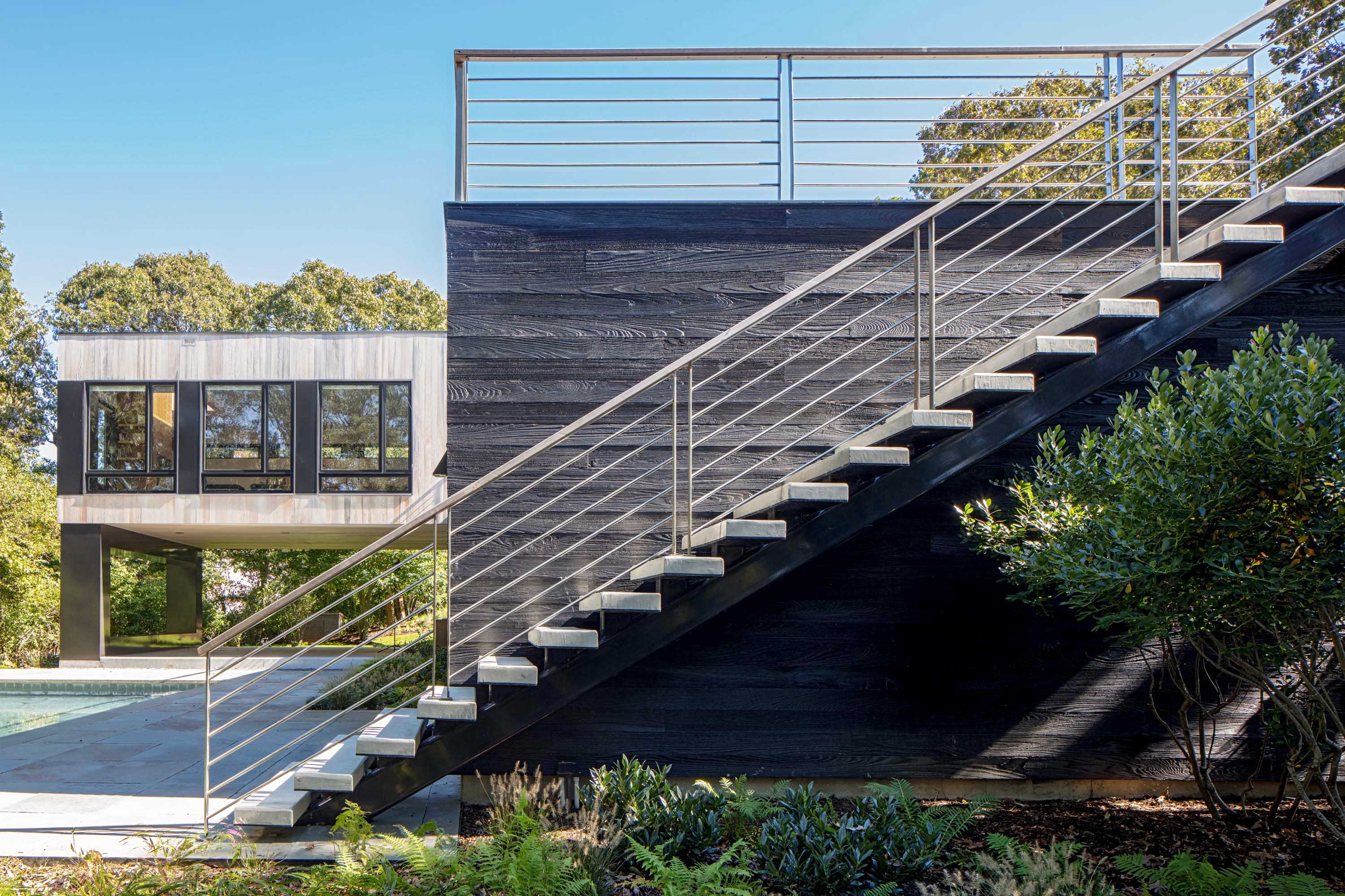 Detail shot of the exterior staircase attached to Bridgehampton House by Specht Novak Architects, shot by Taggart Sorensen.
