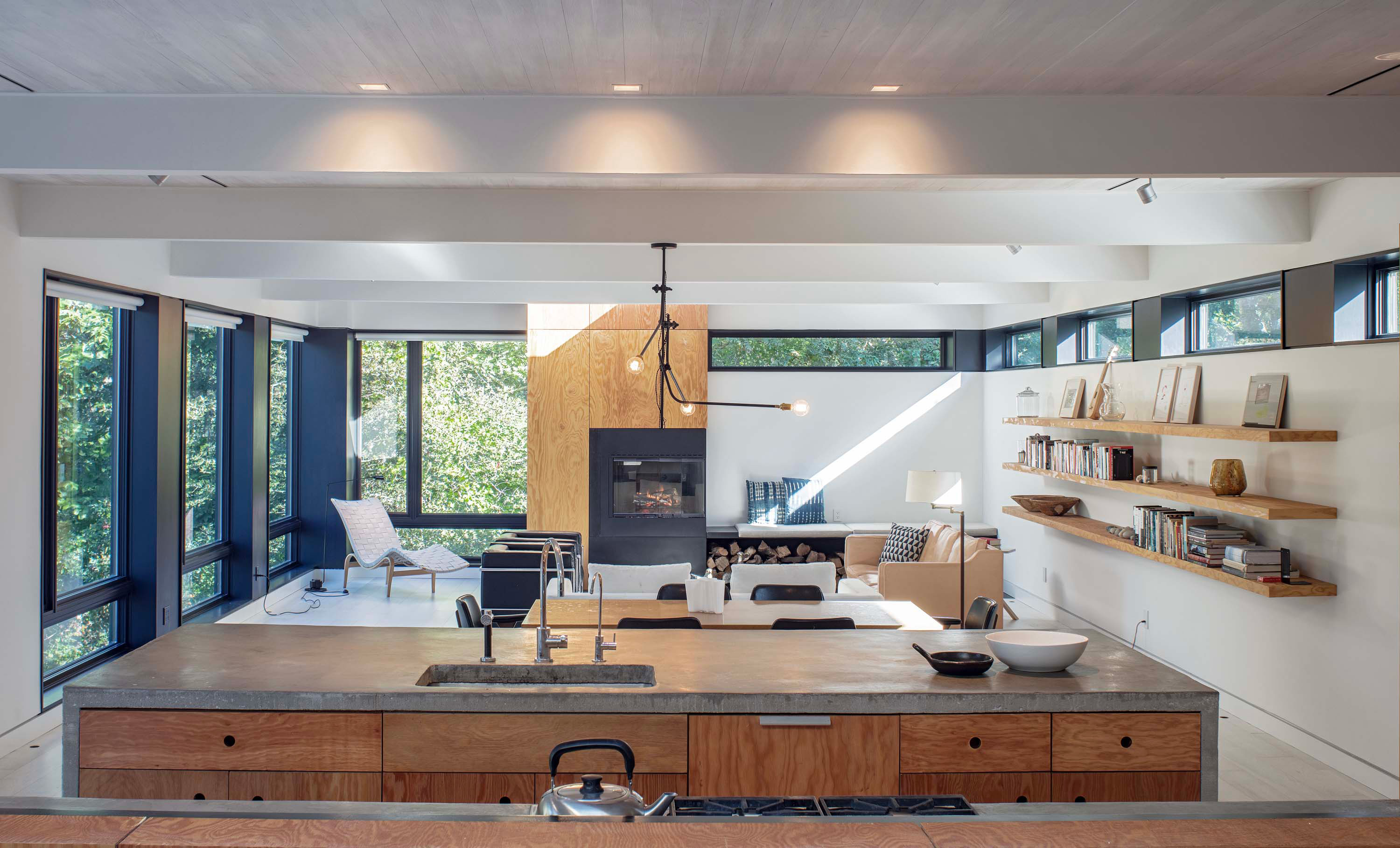 Kitchen shot facing living room by Taggart Sorensen, featuring the open, airy feeling of the Bridgehampton House by Specht Novak Architects.