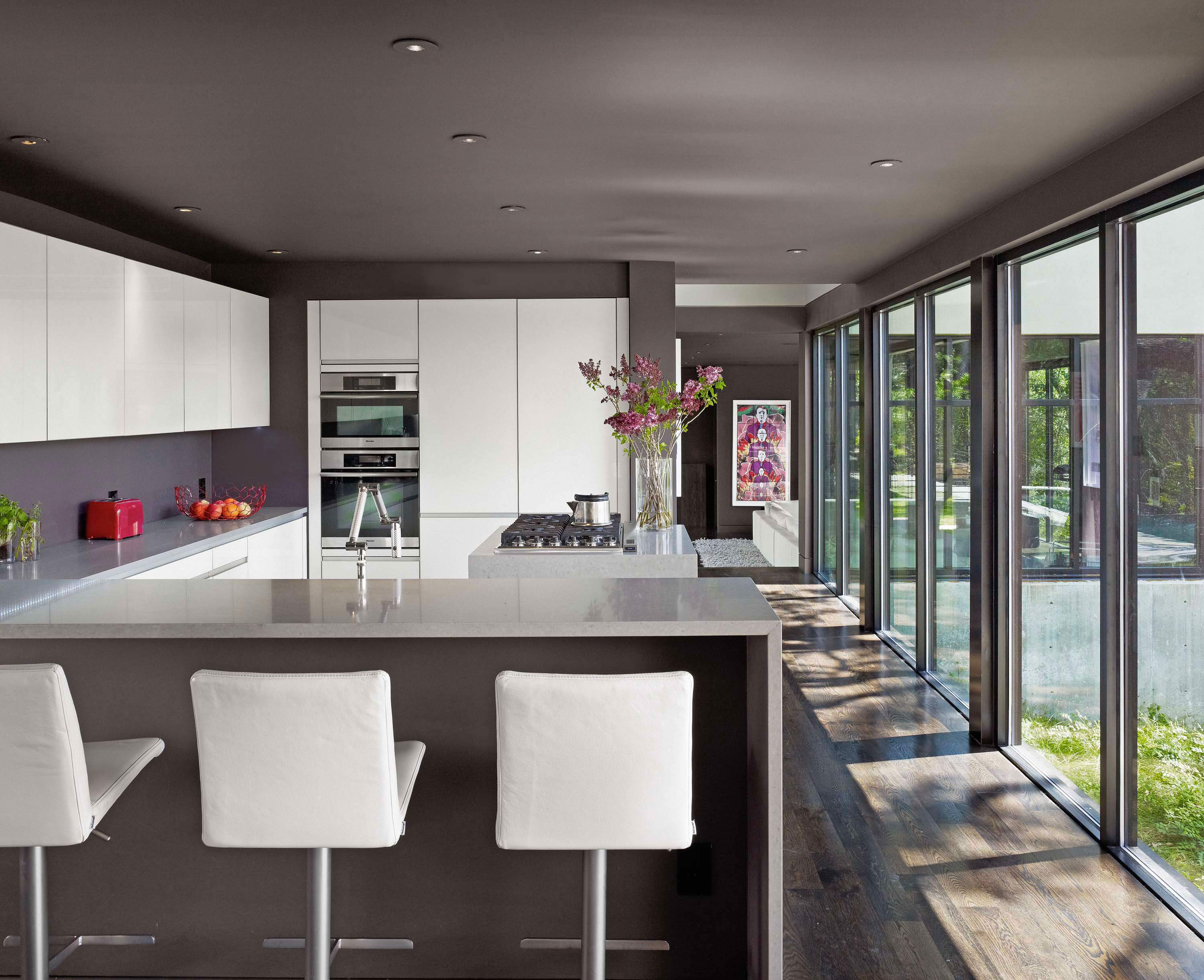Kitchen of West Lake Hills Residence by Specht Novak Architects overlooking the outdoors. Shot by Casey Dunn.