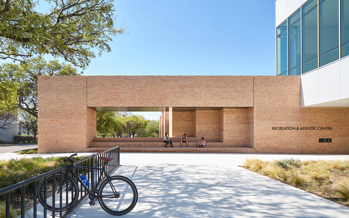 Brick extension of Recreation and Athletic Center by Specht Novak Architects, showcasing the multi-level covered outdoor pavilion. Shot by Andrea Calo.
