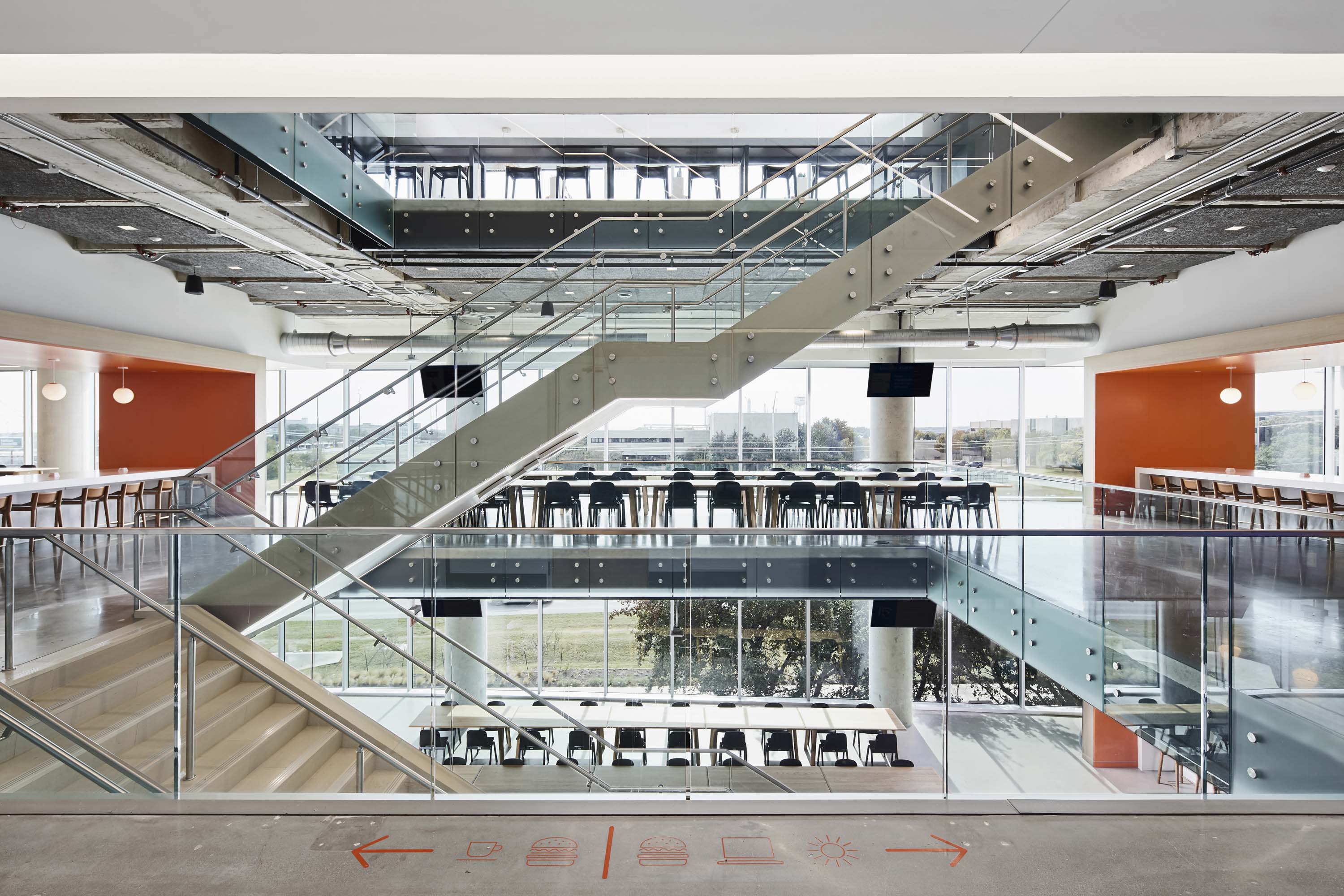 Landing area featuring stairs and open space work areas of Indeed.com in Austin, Texas by Specht Novak Architects, shot by Andrea Calo.