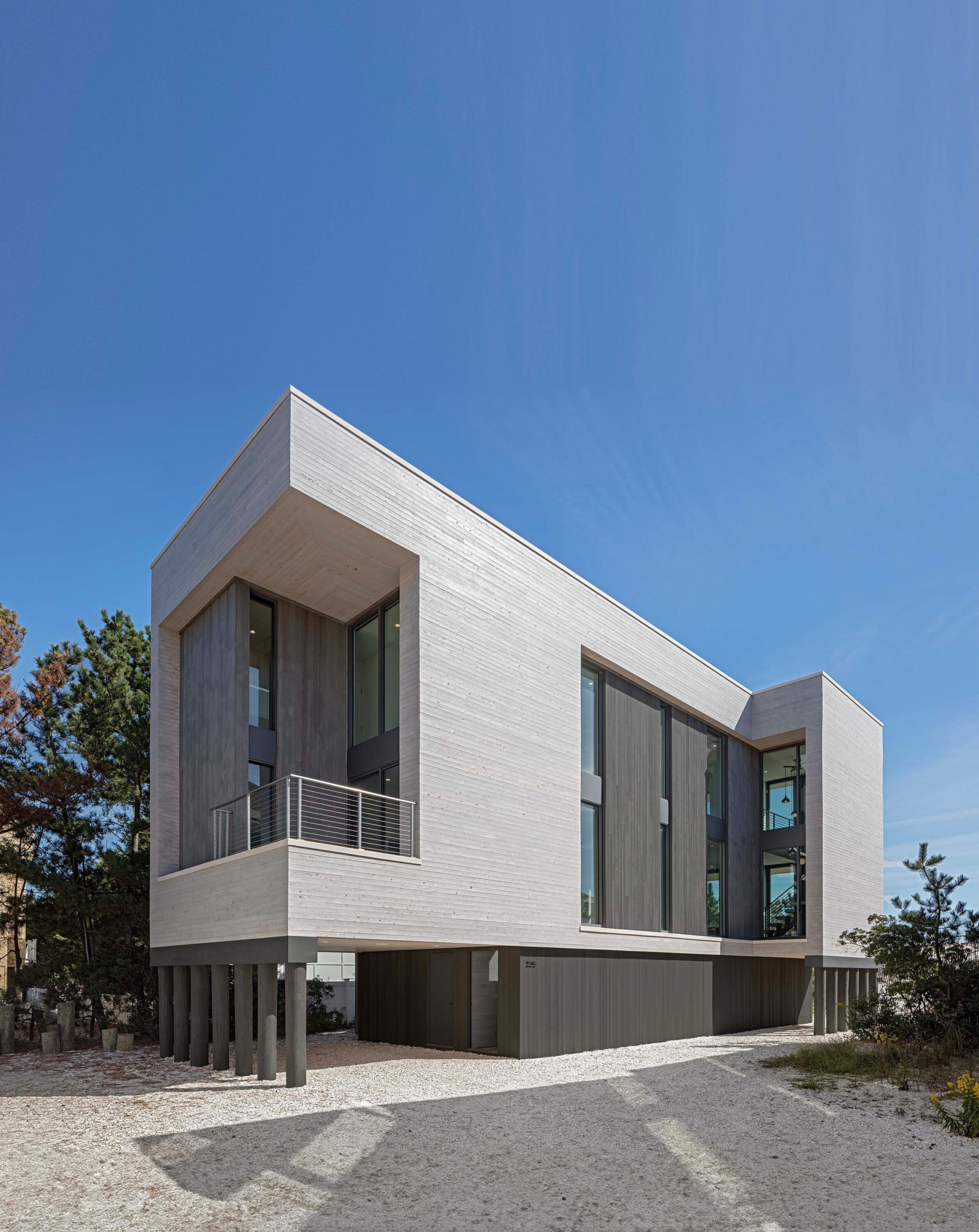 Exterior photo of Beach Haven Residence by Specht Novak Architects, shot by Taggart Sorensen, showcasing the cedar exterior walls of the sculptural form.
