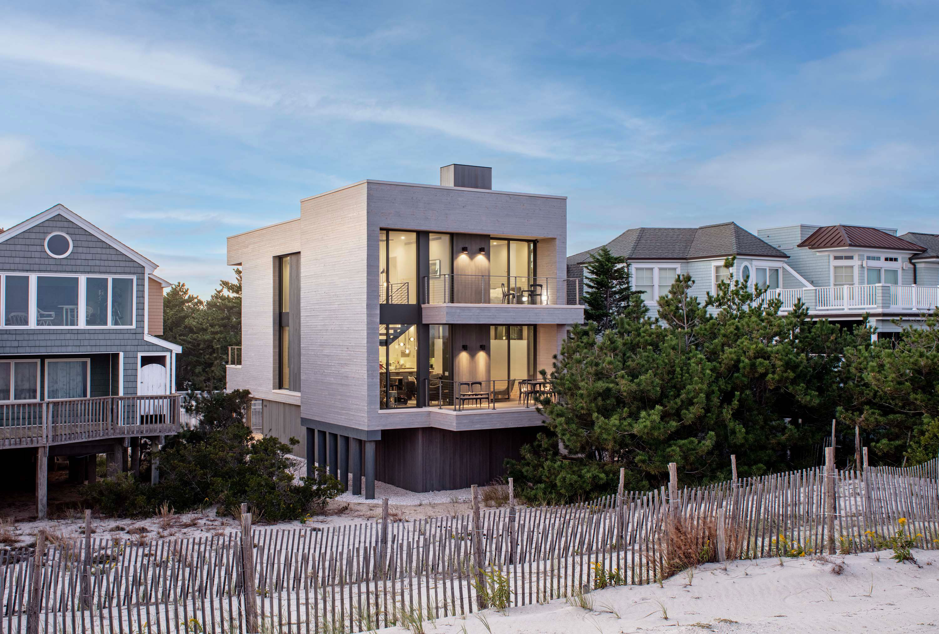 Exterior photo of the Beach Haven Residence by Specht Novak Architects. Shot by Taggart Sorenson featuring the facade of the home and the stylistic contrast amongst the surrounding properties.