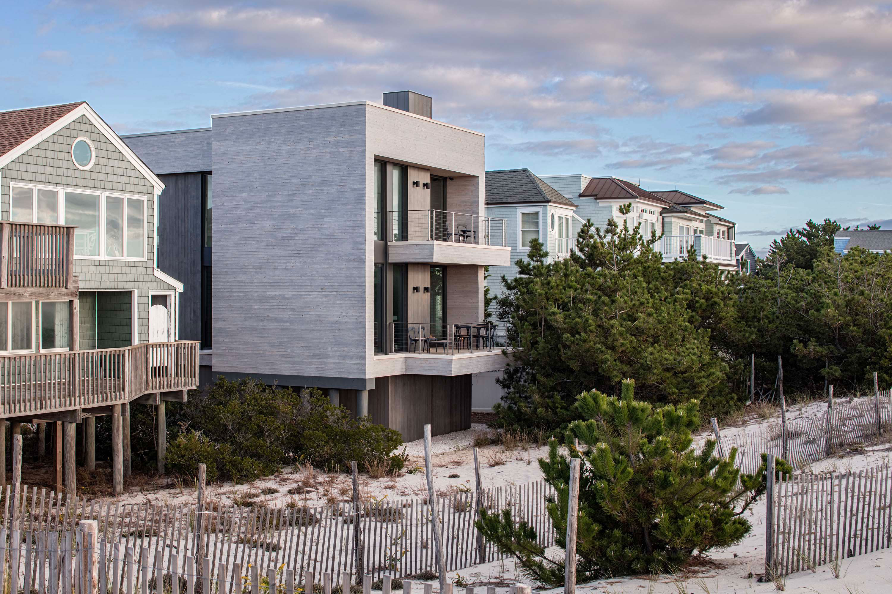 Exterior photo of the Beach Haven Residence by Specht Novak Architects. Shot by Taggart Sorenson featuring the home in relation to the beach and surrounding buildings.