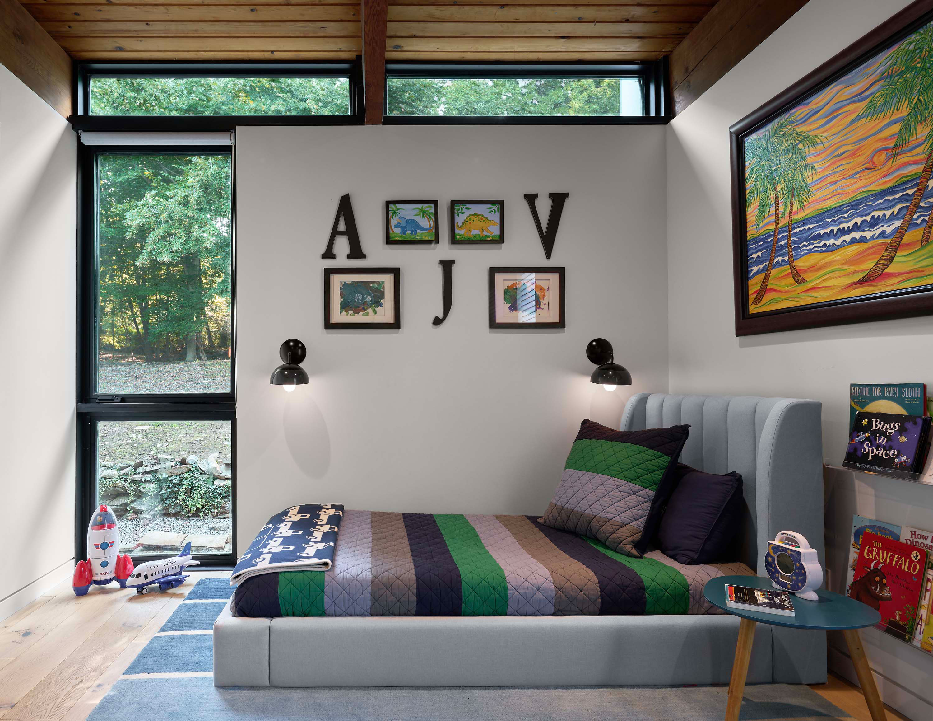 Bedroom of Pelham Manor by Specht Novak Architects showcasing the colorful interior connected visually to the exterior by ample modern windows. Shot by Dror Baldinger.