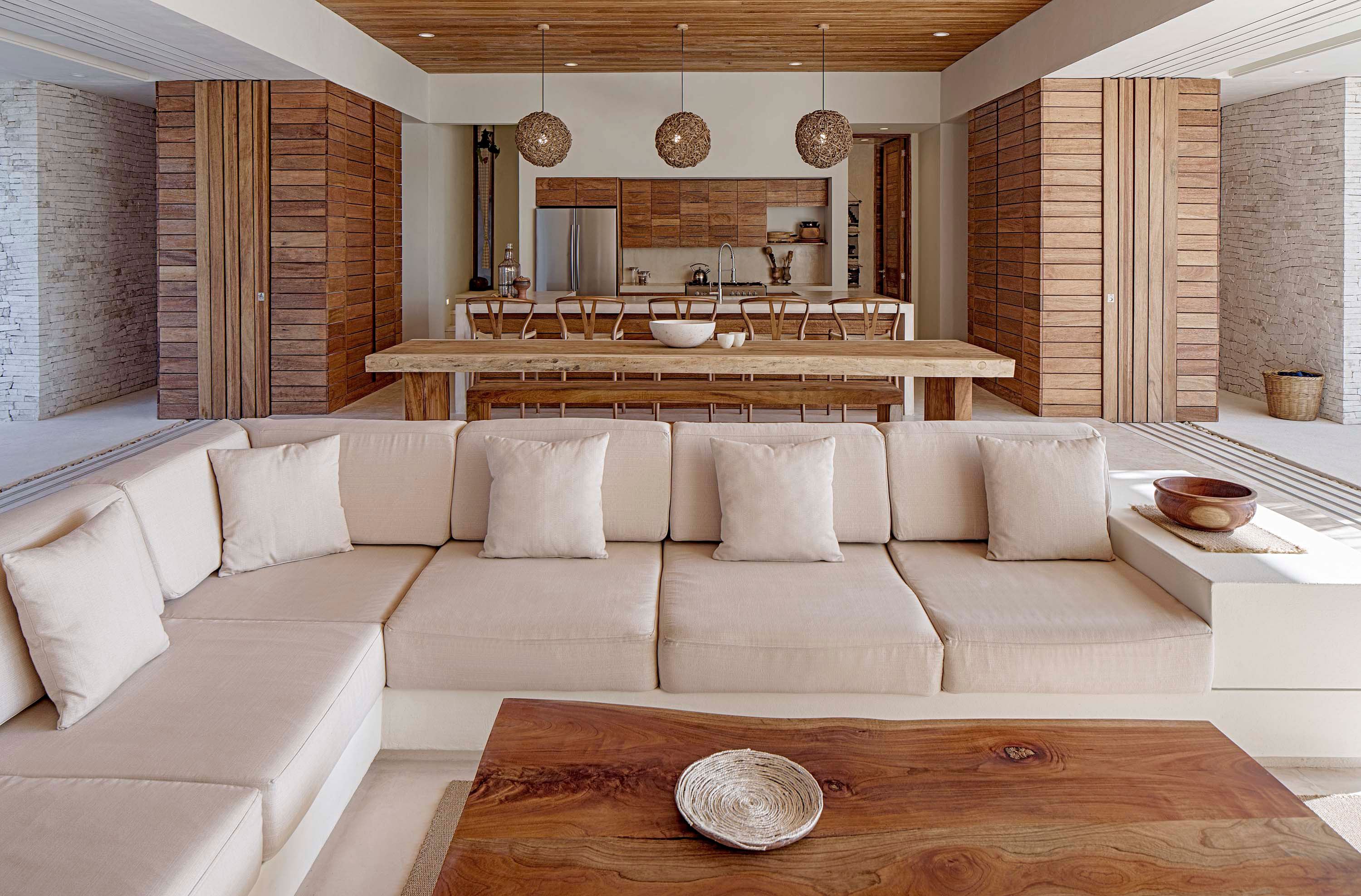 Interior photo of Casa Xixim by Specht Novak Architects. Shot by Taggart Sorensen, featuring living area, wooden accents, and kitchen in the background.