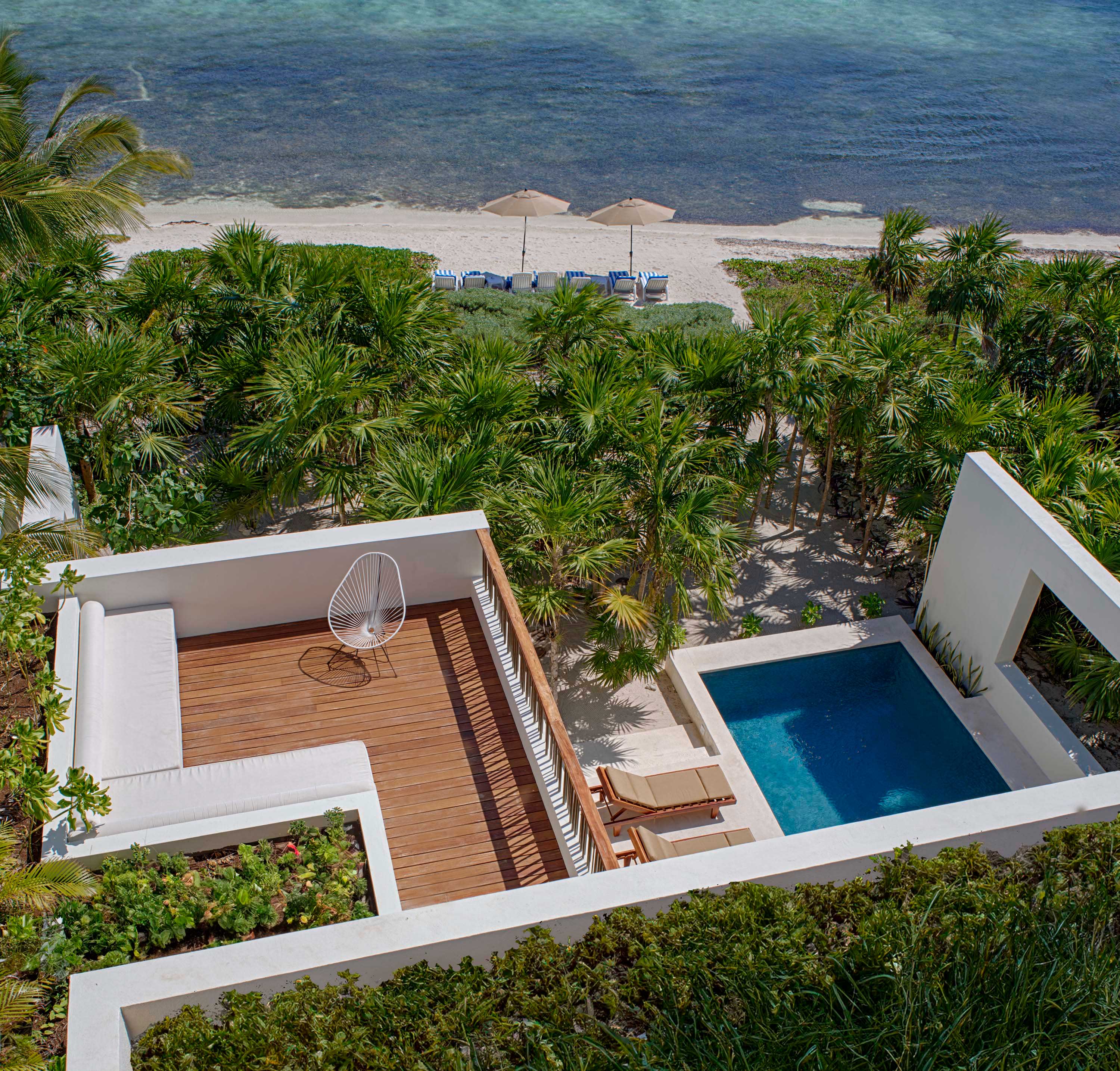 Exterior photo of Casa Xixim by Specht Novak Architects. Shot by Taggart Sorensen, featuring the pool, balcony, and structure of the home from above with view of the ocean.