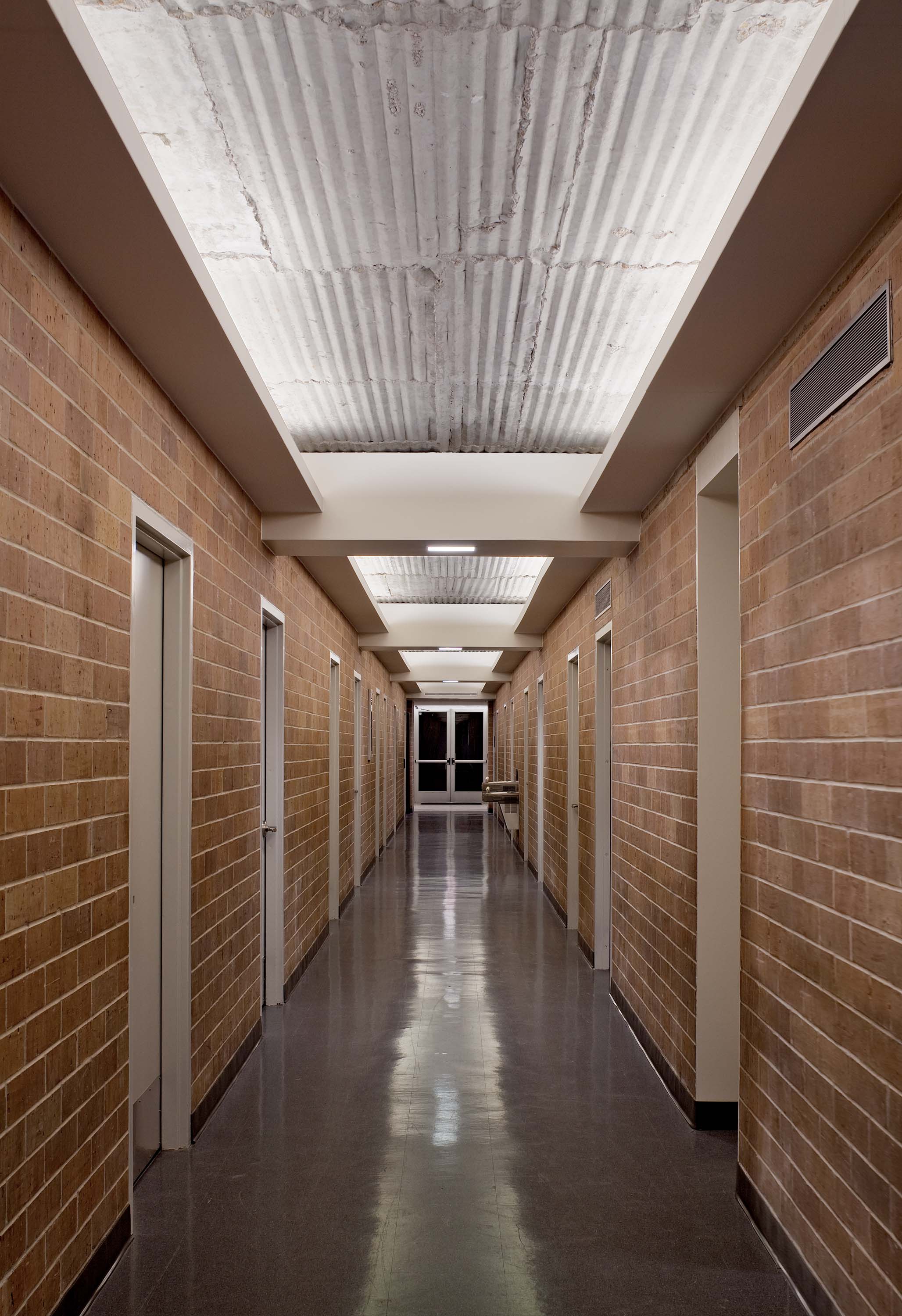 Interior brick-lined hallway of Doyle Hall by Specht Novak Architects. Shot by Taggart Sorensen.