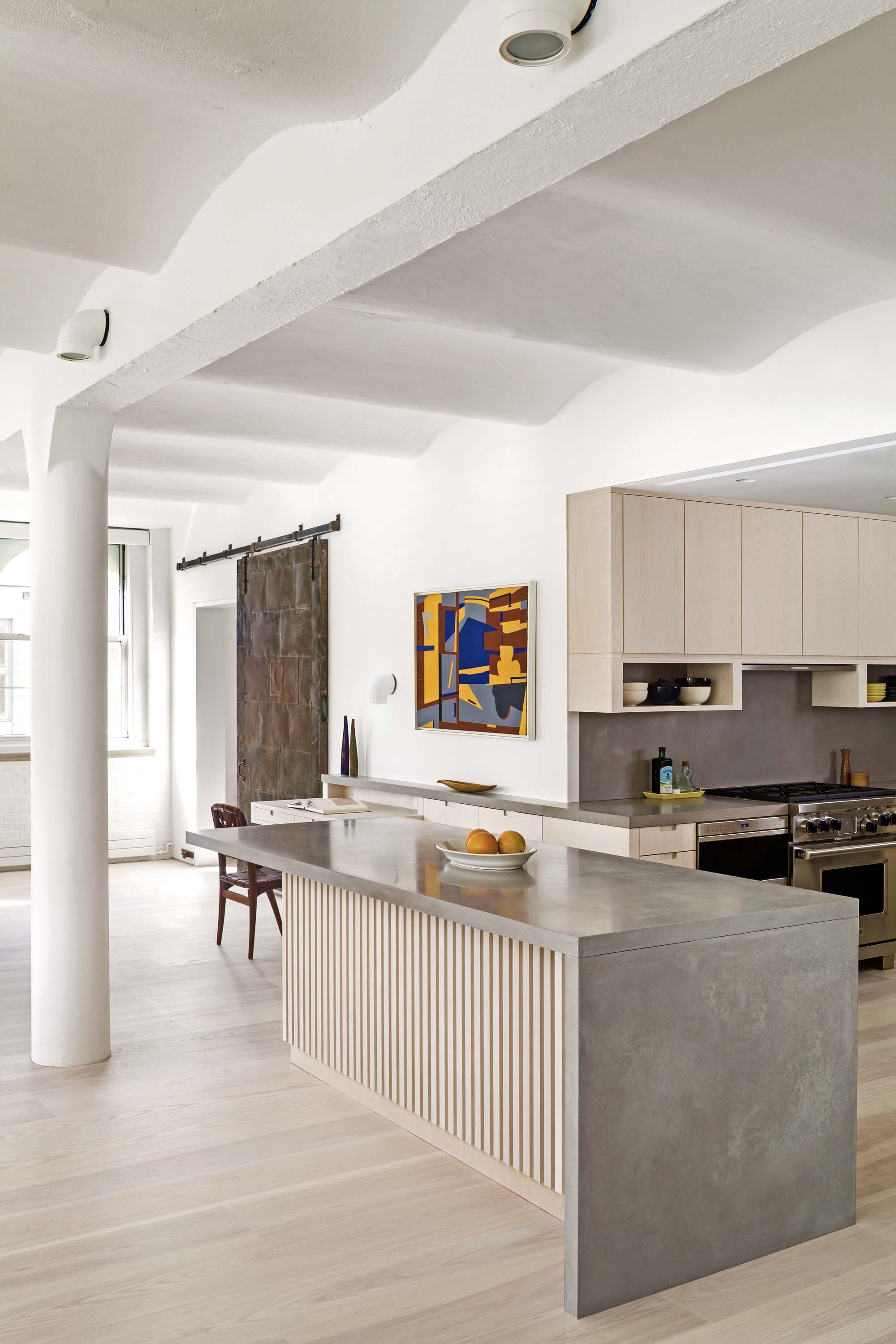 Shot of kitchen island, highlighting original vaulted concrete ceiling in Greenwich Street Loft by Specht Novak Architects. Shot by Andrea Calo.