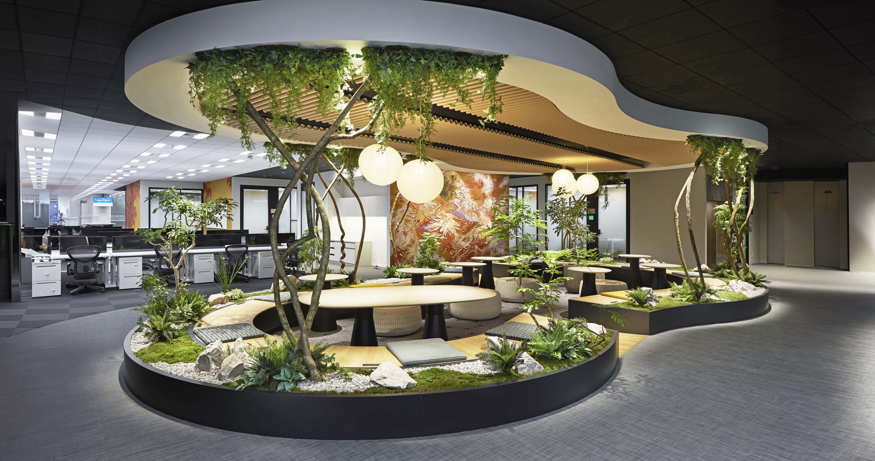 Communal workspace featuring greenery and soothing overhead lighting in Indeed.com Tokyo, Japan by Specht Novak Architects.